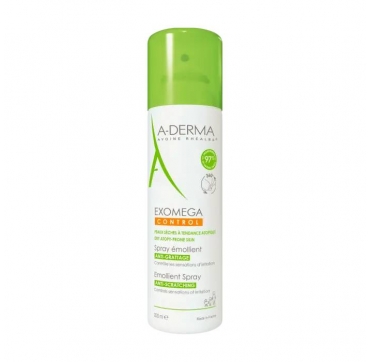 A-derma Exomega Control Emolijentni sprej 200 ml bočica na bijelom zidiću uz travu